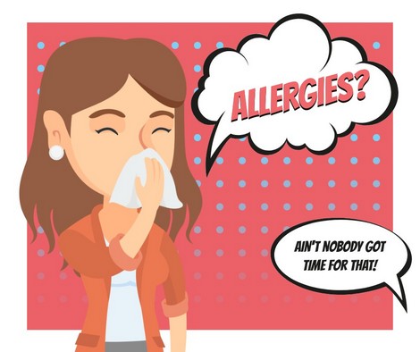 woman blowing nose due to allergies