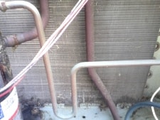 A clean outdoor coil drastically improves efficiency. outdoor coil after removing grass clippings