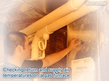 A service technician is checking the air temperature going into the furnace and coming out of the furnace. checking the return air temperature with a digital thermometer