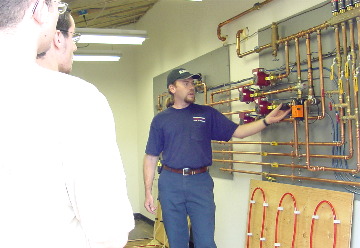 Nothing beats the comfort or efficiency of a Radiant Heating System installed by Hannabery HVAC! Hannabery technician teaching students on the radiant trainer