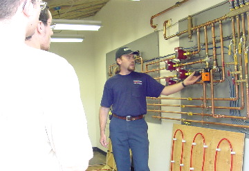 Hannabery technician teaching students on the radiant trainer